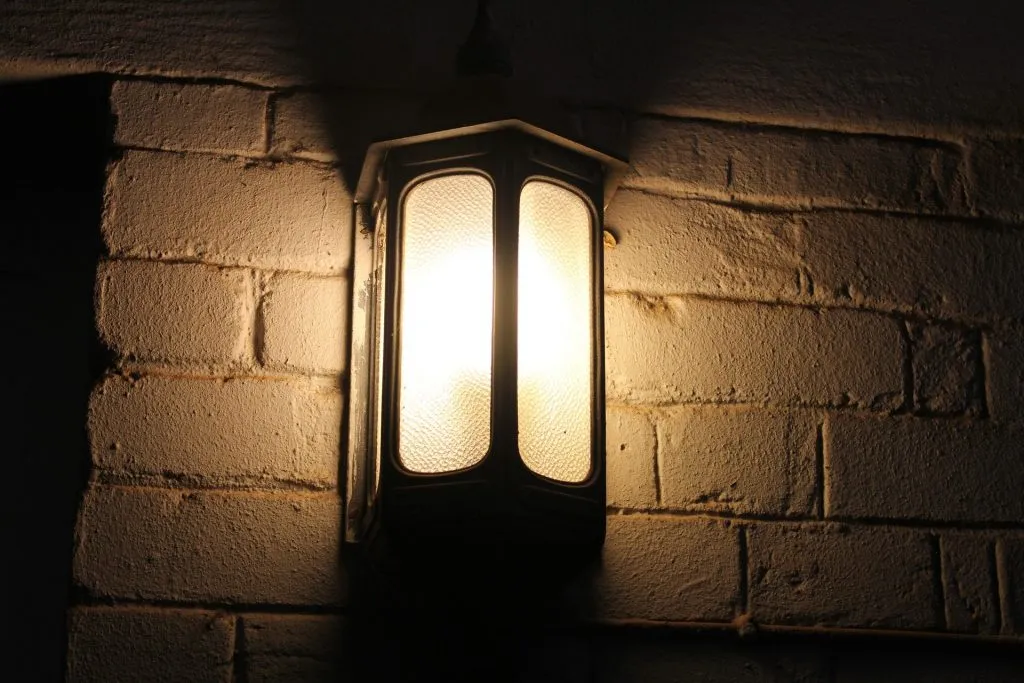 a light that is on a brick wall.