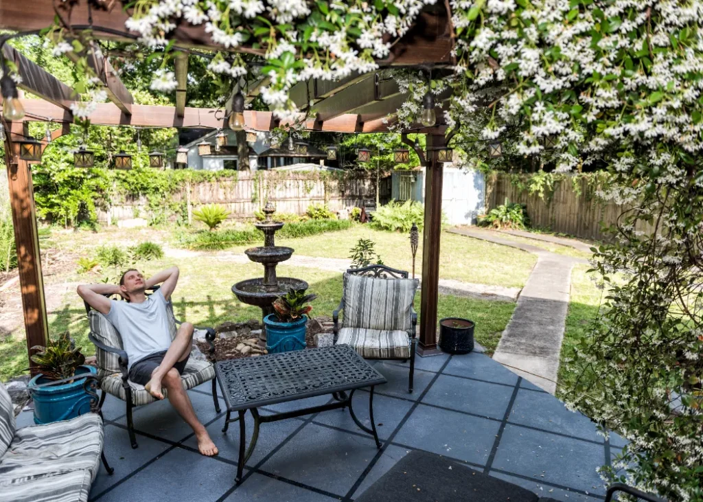 Man relaxing in his backyard with outdoor fountains