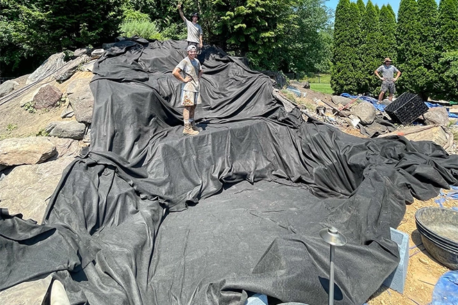 Huge koi pond liner covering waterfalls as well